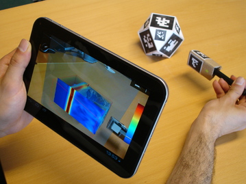 Real objects used to slice a virtual volume behind a tablet, result displayed on the tablet's screen.